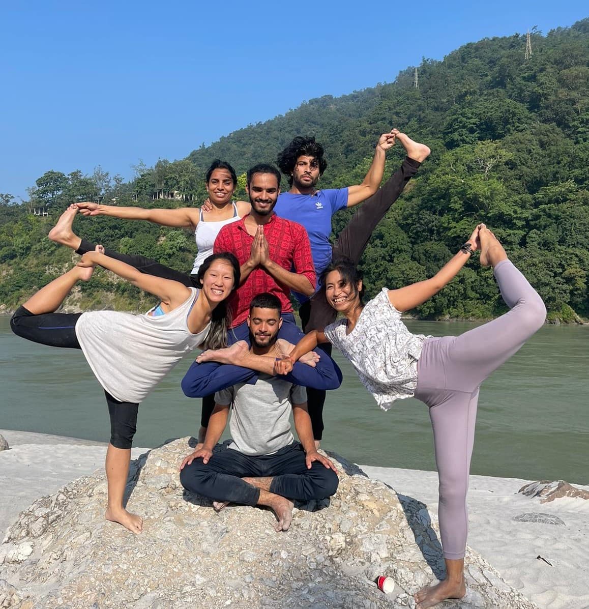 Bunch of people doing yoga poses